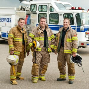 three smiling firefighters