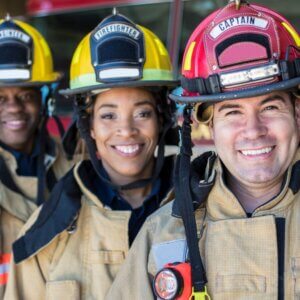 three smiling firefighters