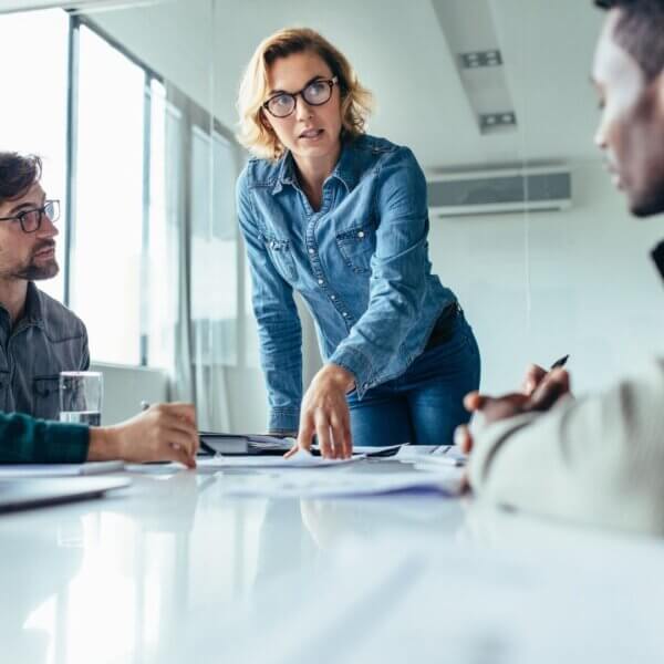 woman stands while leading meeting