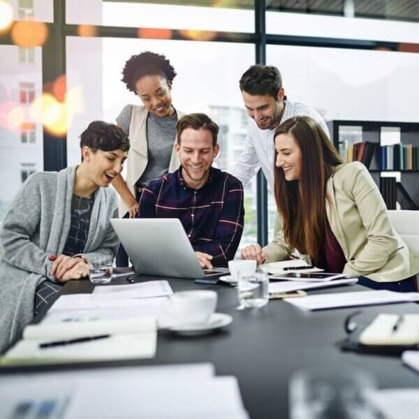people gather around computer screen 