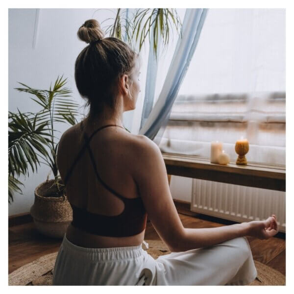 Woman meditating in a calm, indoor space