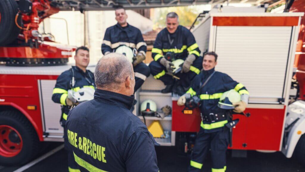 fire chief stands in front of crew