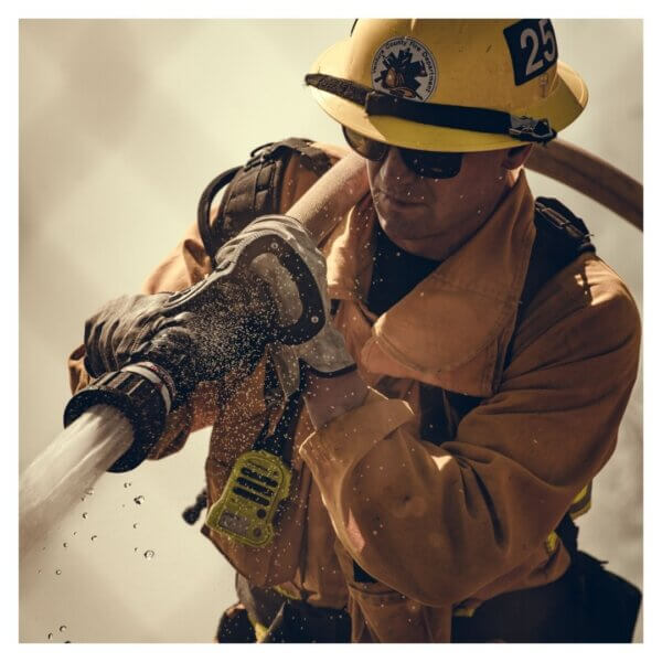 Firefighter spraying water from a hose in action