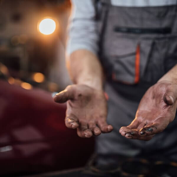 Dirty hands of a mechanic after working on a car