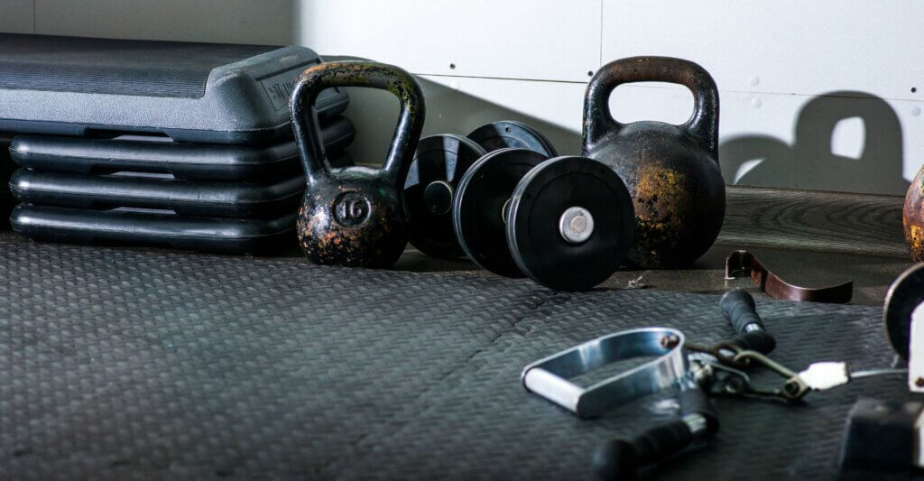 Kettlebells and dumbbells in a gym setting