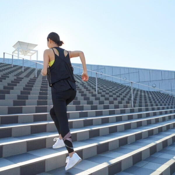 a woman running up steps