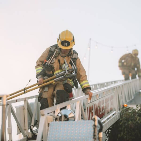 a firefighter walking down a ladder